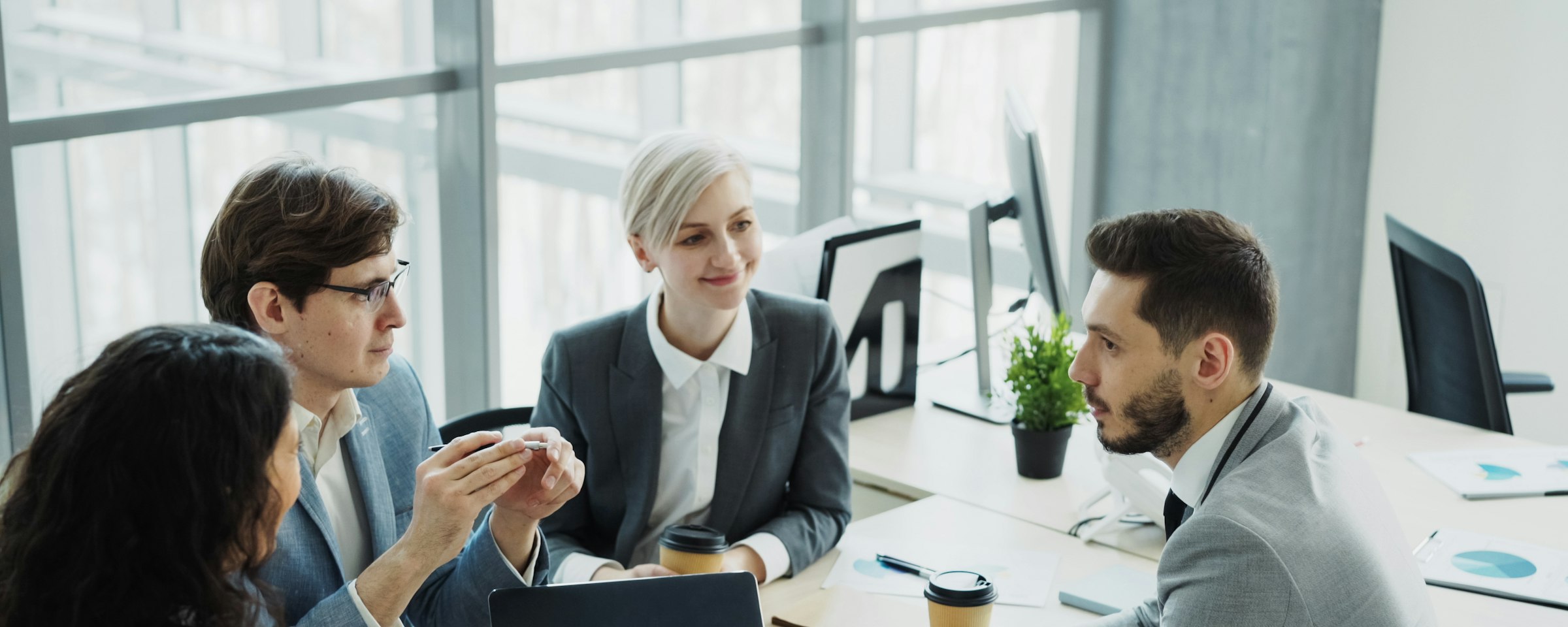 A recruiting team meeting around a table in a bright office
